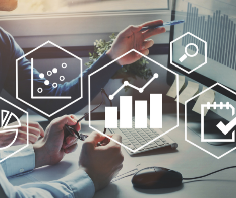 Graph and chart icons overlaying a background image of two people pointing at a computer screen looking at financing information. Symbolizing business valuation